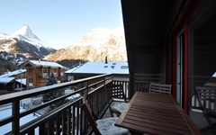 Haus-Gamma-studio-gamma-balcony-with-table-chairs-and-matterhorn-in-the-back