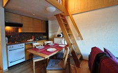 Haus-Gamma-studio-gamma-dining-area-with-kitchen-in-the-background-and-stairs