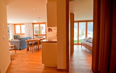 Casa-D'Amore-Zermatt-interior-view-dining-area-kitchen-bedroom-and-living-area